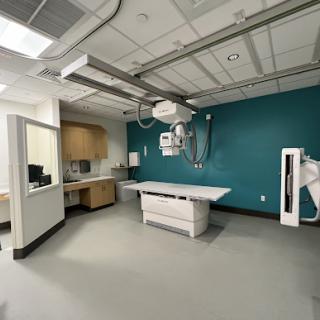 A well-equipped medical examination room ideal for x-ray procedures.