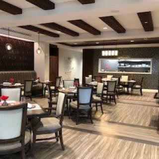 A modern restaurant dining area with neatly arranged tables and chairs.