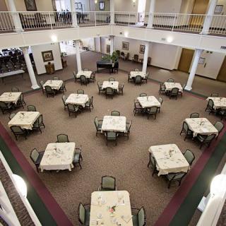 An indoor dining hall with neatly arranged tables and chairs.