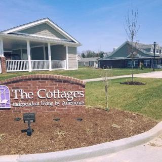 The Cottages assisted living facilities with a welcoming sign and well-maintained landscape.