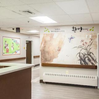 A welcoming hospital interior featuring a reception desk and decorative wall art.