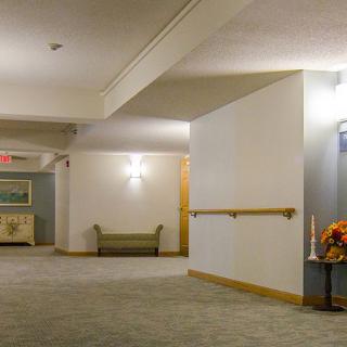 A well-lit hallway with a sofa and decor.