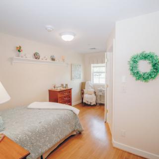 A cozy and well-decorated bedroom with soft lighting and minimalistic design.