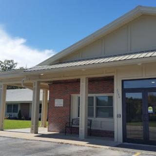 A view of a modern building entrance on a clear sunny day.