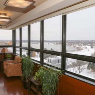 A cozy sitting area with a panoramic view through large windows.