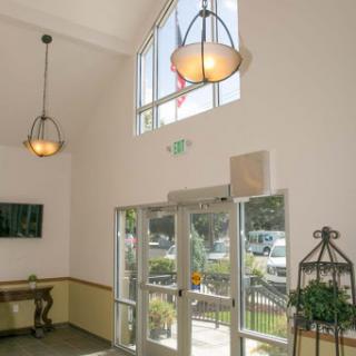 A bright and welcoming lobby featuring modern lighting and large windows.