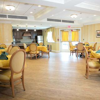 A bright and elegant dining room with neatly arranged tables and chairs.