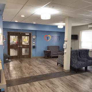 A spacious and welcoming waiting area in a healthcare facility, featuring comfortable seating and modern decor.