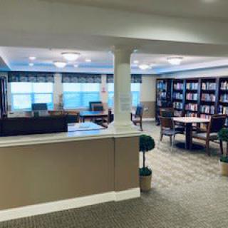 A quiet library with bookshelves and a reading area.