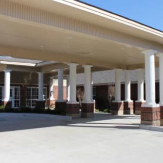 A building entrance featuring multiple columns and a covered walkway.