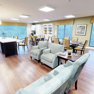 A spacious and modern living and dining area with comfortable seating and large windows.