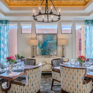 An elegant dining room with a beautifully set table and stylish decor.