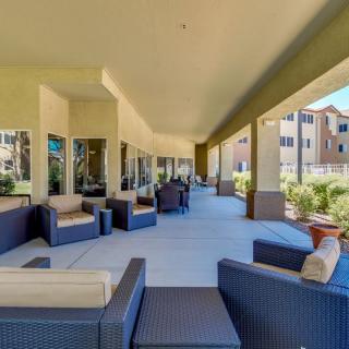 Spacious outdoor patio area with comfortable seating at an apartment complex.