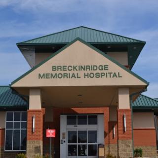 Facade of Breckinridge Memorial Hospital under a clear sky.