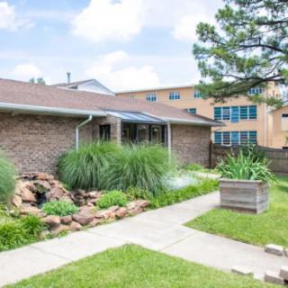 A suburban house with a landscaped garden and a walkway.