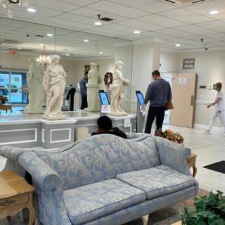 A modern lobby with sculptures and a comfortable waiting area.