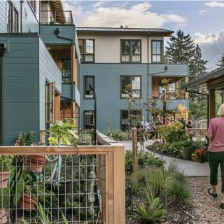 A community-focused cohousing development with lush gardens and shared outdoor spaces.