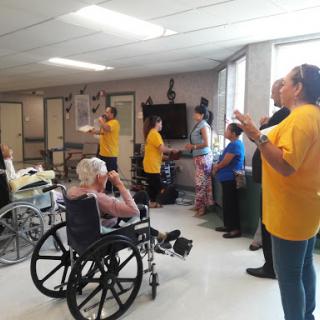 Residents and staff engage in an interactive activity to promote joy and social interaction.