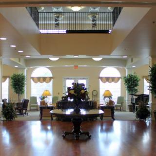 A well-lit hotel lobby with elegant furniture and decor.