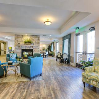 A modern and spacious living room with a cozy seating area and a fireplace.