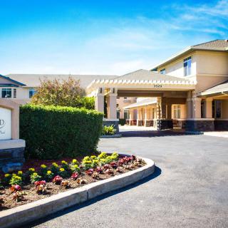 A well-maintained building with a welcoming entrance and landscaped surroundings.