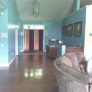 A cozy living room with blue walls and wooden floors, featuring a sofa and decorative elements.