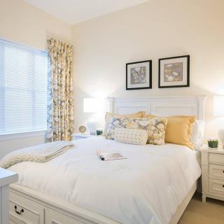 A cozy bedroom with elegant decor and a comfortable bed.