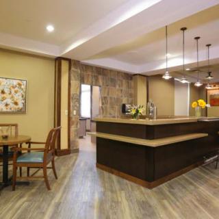 A modern kitchen with an island counter and stylish pendant lights.