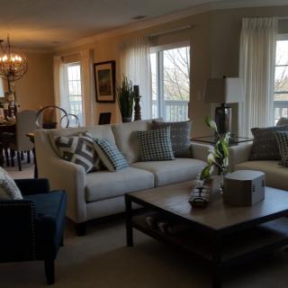 A cozy living room with a dining area, featuring comfortable sofas and a stylish coffee table.