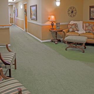 A cozy hallway with comfortable seating and warm lighting.