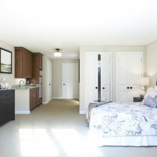 A bright and modern bedroom with sleek furnishings and neutral colors.