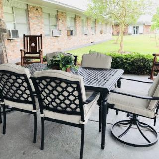 A cozy outdoor seating area featuring a table and chairs, perfect for enjoying the fresh air.