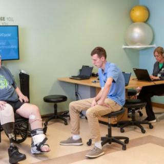 A physical therapy session with a patient and therapist, focusing on rehabilitation exercises.