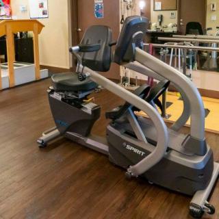 A recumbent exercise bike in a gym setting.