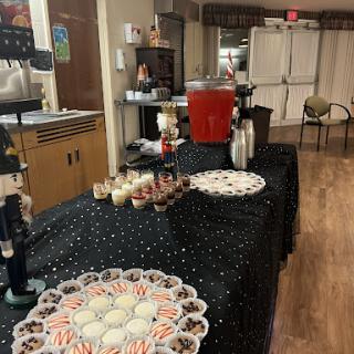 A festive setup featuring a variety of desserts and drinks for an event.