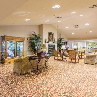 A spacious and warmly decorated lobby with comfortable seating arrangements.