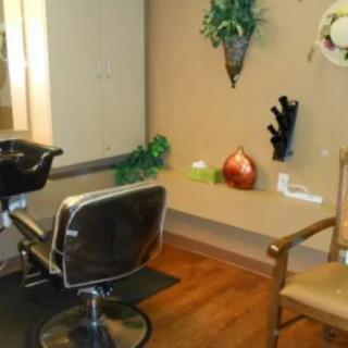 A cozy salon interior with a hairdresser chair and decorative elements.