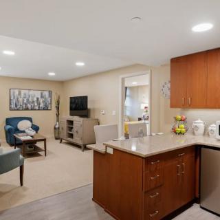 A modern open-concept living area with a kitchen and comfortable seating.