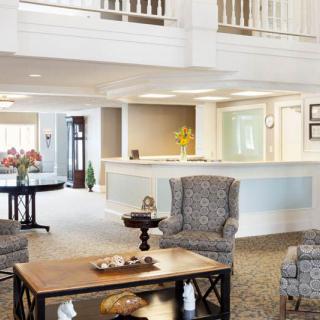 A modern lobby area with comfortable seating and a reception desk.