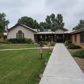 A charming residential building with a well-maintained garden and walkway.
