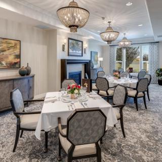 Elegant dining room with chandeliers and sophisticated table settings.