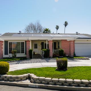 A suburban house with a well-maintained front yard and landscaping.