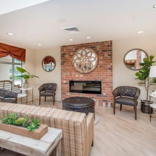 A cozy living room with a brick fireplace and elegant decor.
