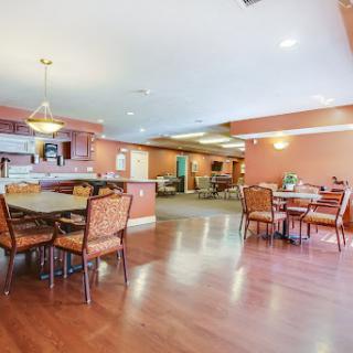 A cozy and inviting dining/lounge area with wooden floors and comfortable seating.