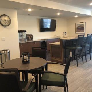 A modern indoor bar area with seating and a television.