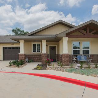 A modern residential home with a front porch and attached garage.