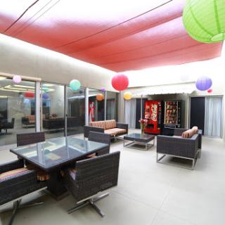 A modern lounge area with comfortable seating and colorful decorative elements.