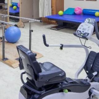 A rehabilitation room equipped with exercise machines and therapy equipment.