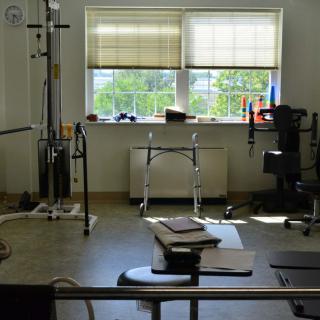 A well-equipped physical therapy and rehabilitation room with various exercise equipment.