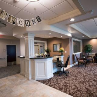 A reception area with a welcome sign and a comfortable waiting space.